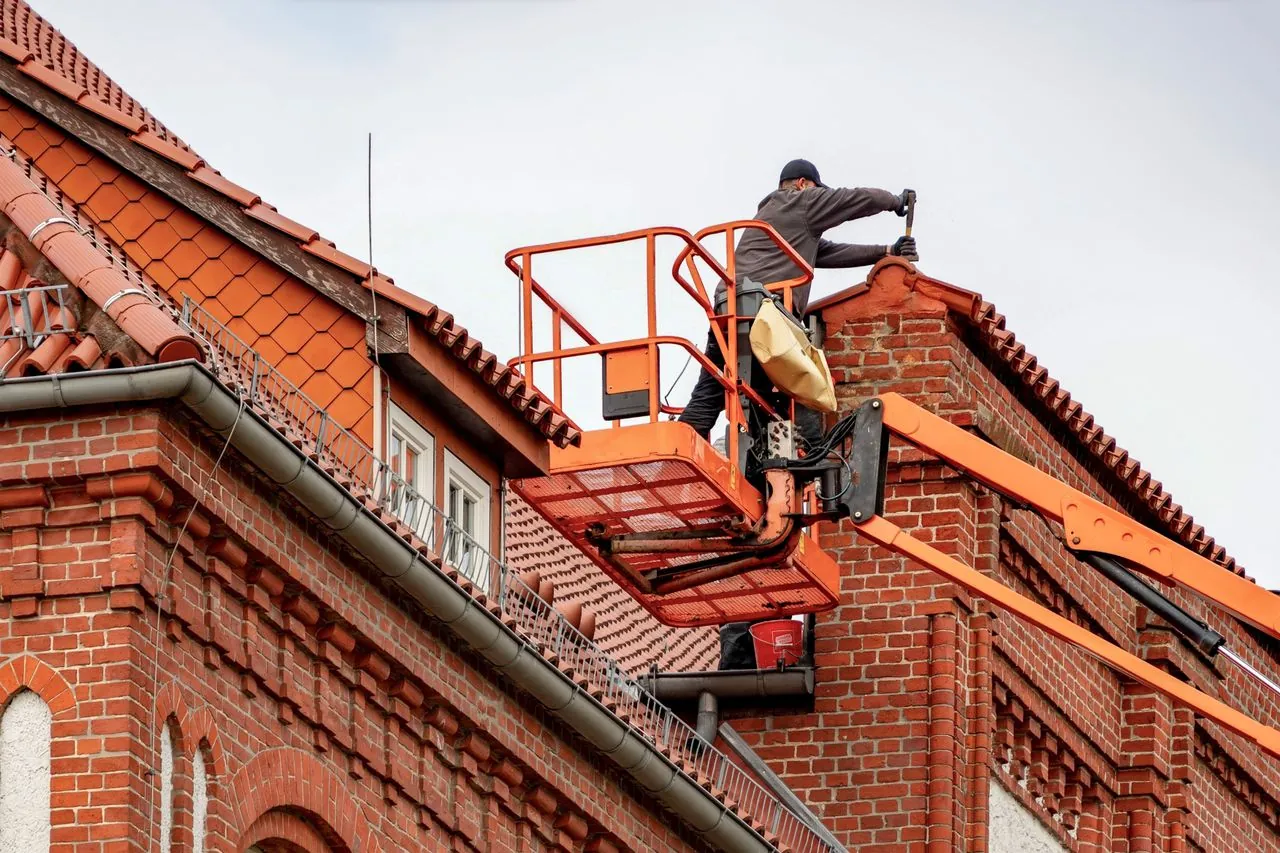 Commercial roofers performing maintenance on a flat roof building